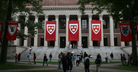 Exterior shot of Harvard's Harry Elkins Widener Memorial Library, students walking around nearby
